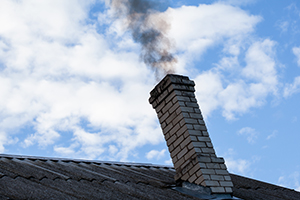 smoking chimney emitting black smoke